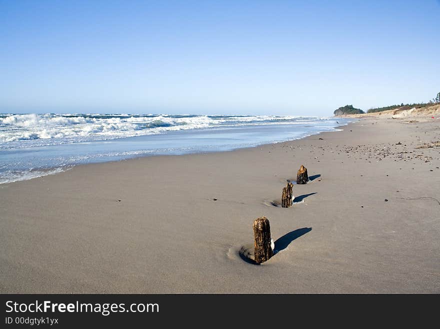 Low perspective, wooden pegs. Seaside. Low perspective, wooden pegs. Seaside.