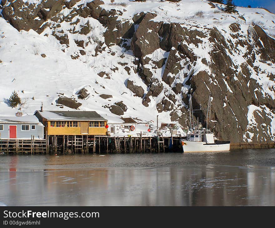 Fishing stages next to a frozen harbour