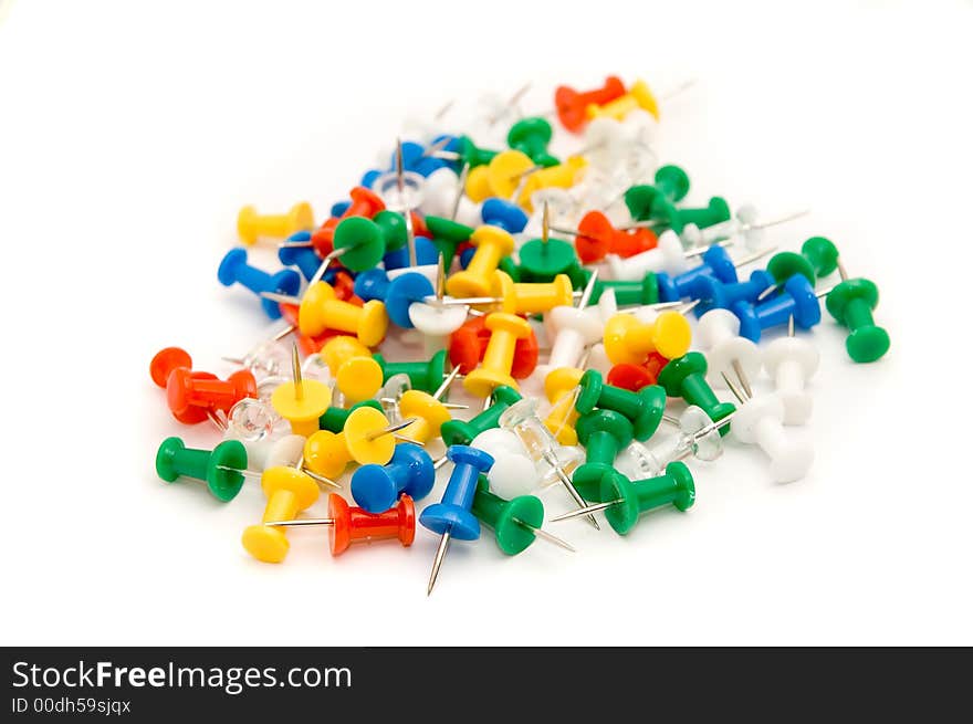 Colorful pushpins against white background