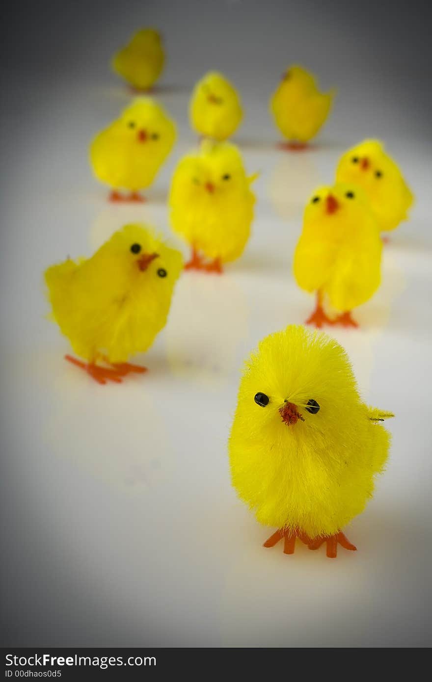 Yellow easter toy hens on the reflective background. Yellow easter toy hens on the reflective background