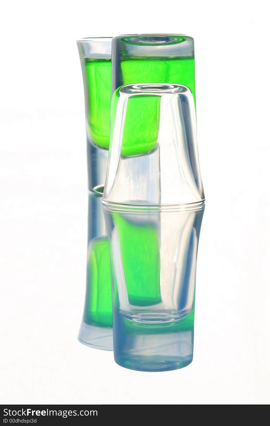 Two wine-glasses, one is filled by green drink