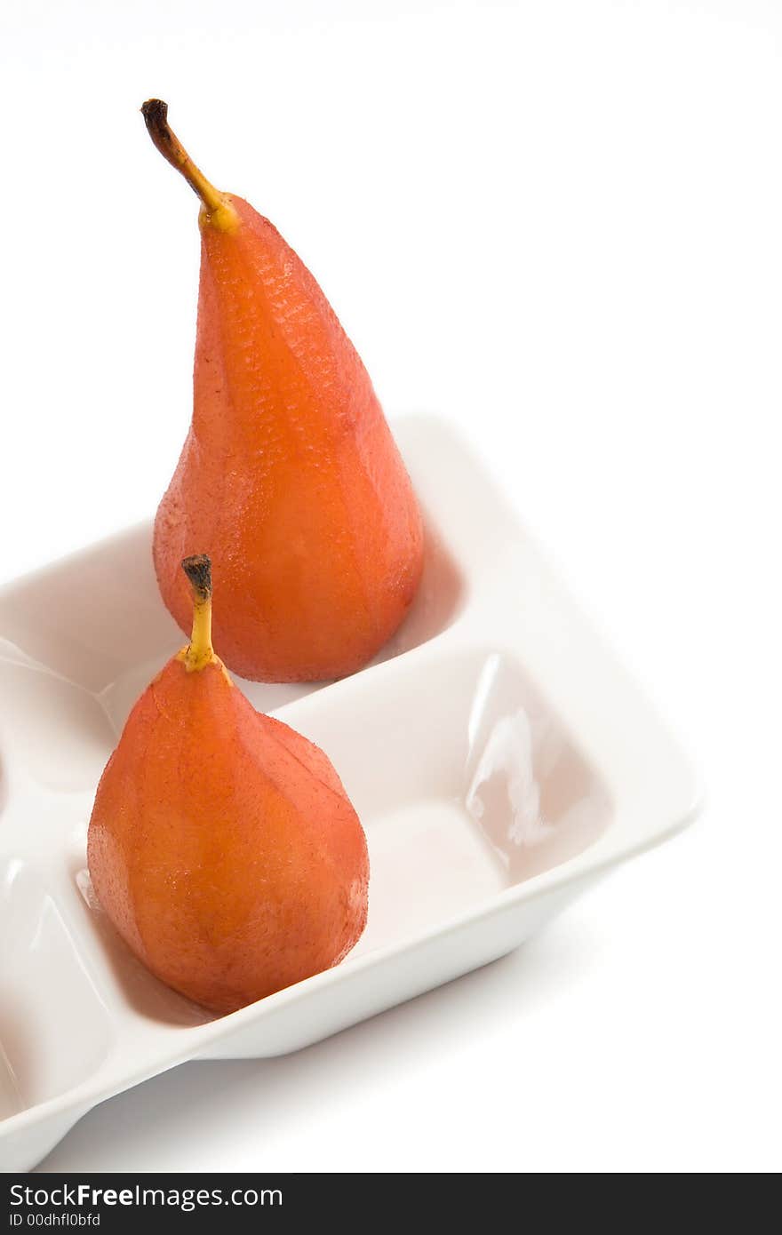 Close-up of two pears poached in red wine