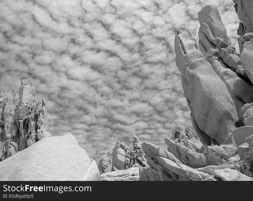 Rocks of many different formations with a background of a cloudy sky in Cabo San Lucas, Mexico. Rocks of many different formations with a background of a cloudy sky in Cabo San Lucas, Mexico.