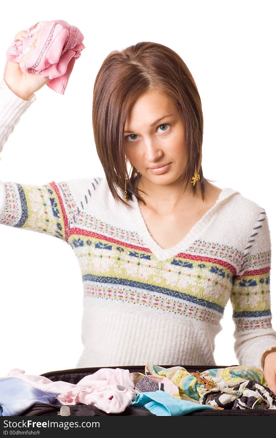 Picture of a Beautiful young girl packing her clothes. Picture of a Beautiful young girl packing her clothes