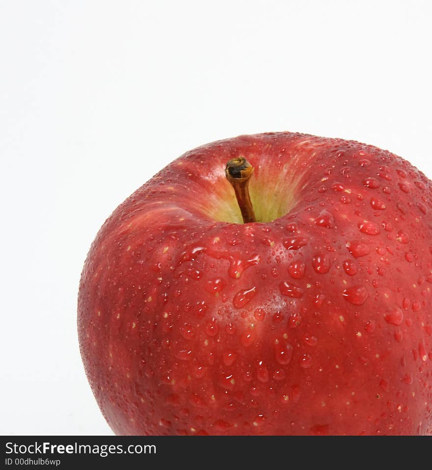 Red apple with drops on white background