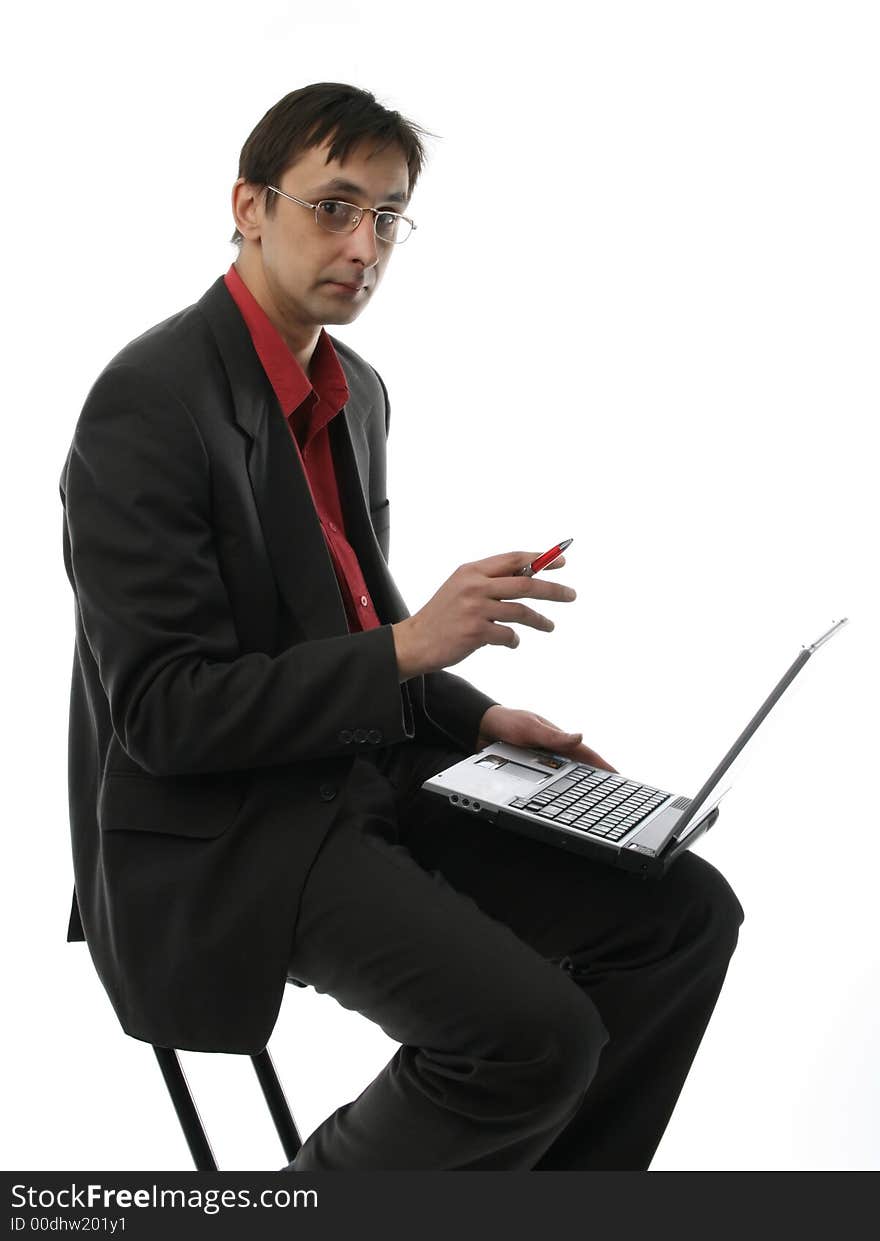 The businessman sits with laptop