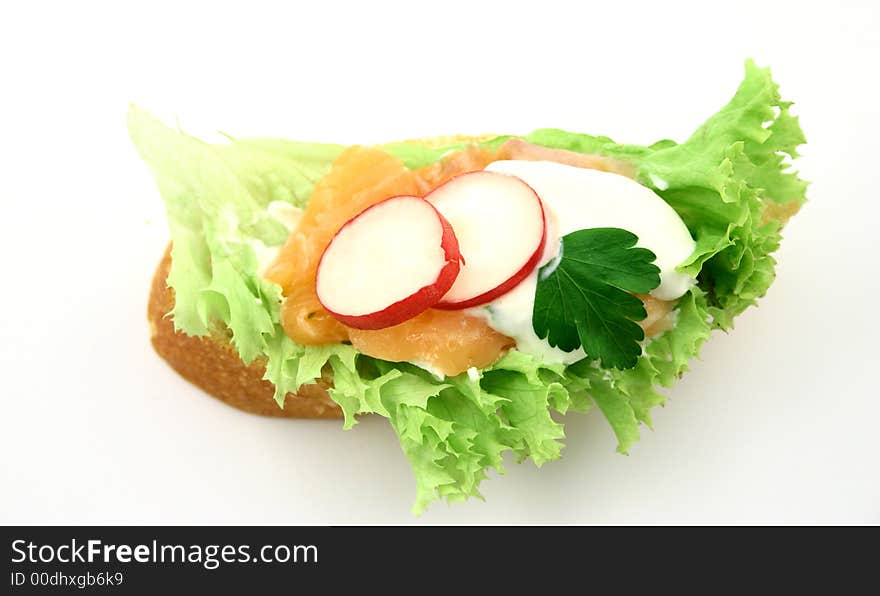 Top view at tasty salmon's sandwich with radish, tzatziki and piece of parsley