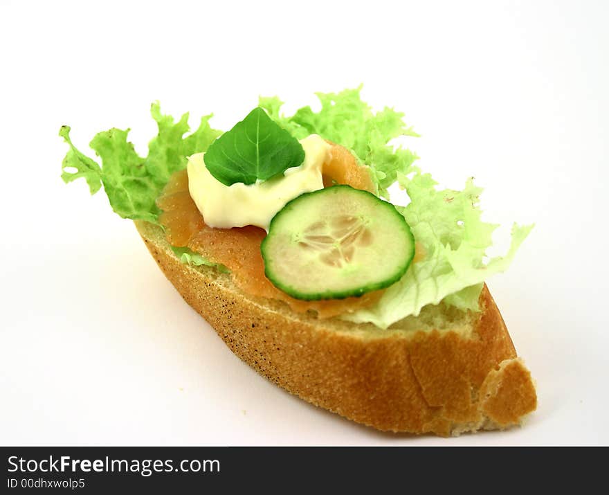 Fresh sandwich with salmon, cucumber, iceberg lettuce piece of basil and mayonnaise. Fresh sandwich with salmon, cucumber, iceberg lettuce piece of basil and mayonnaise