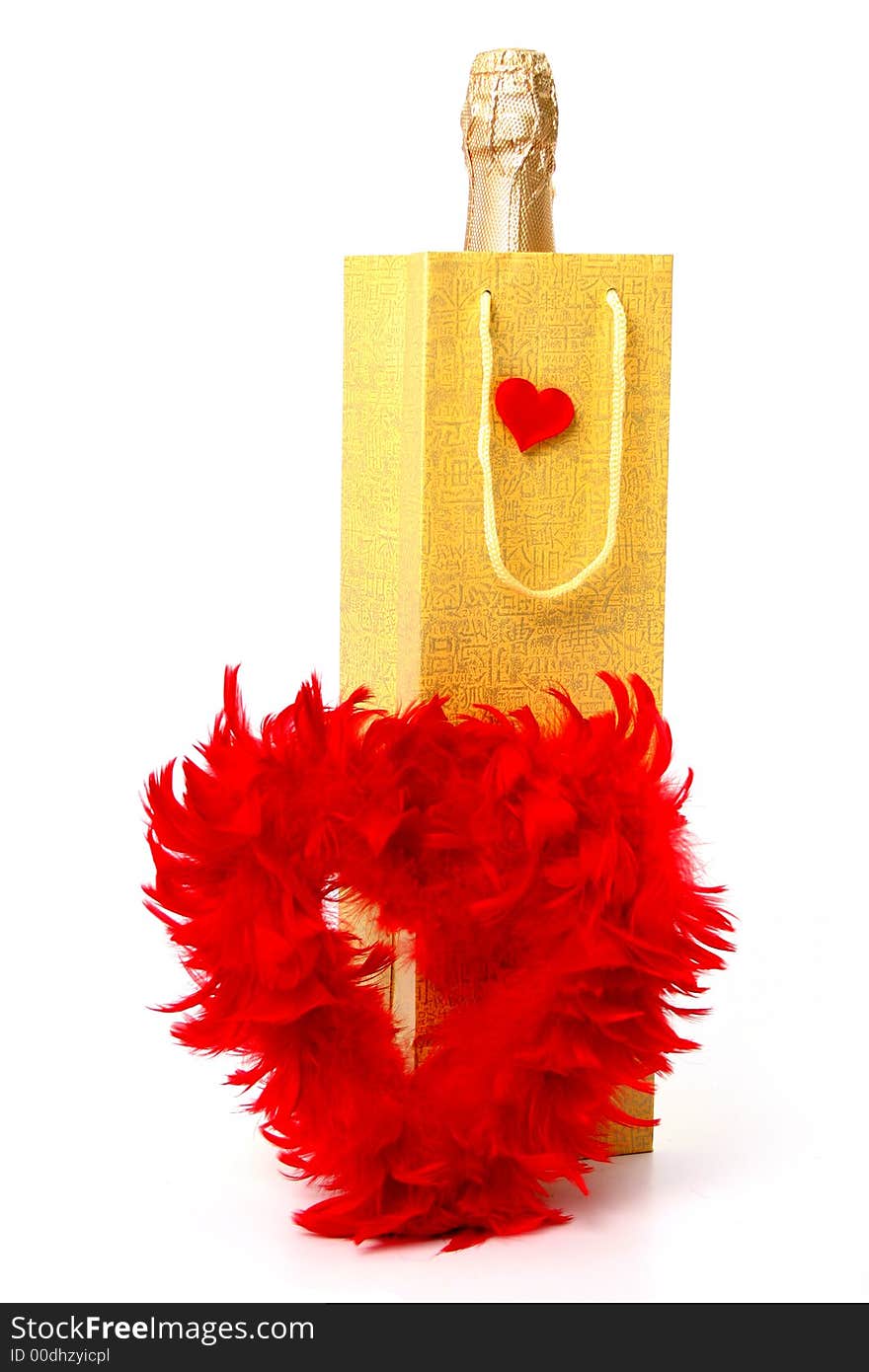 Bottle with a champagne and heart made of red feathers