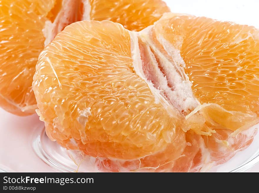 Half of juicy pink grapefruit on a glass plate. Half of juicy pink grapefruit on a glass plate