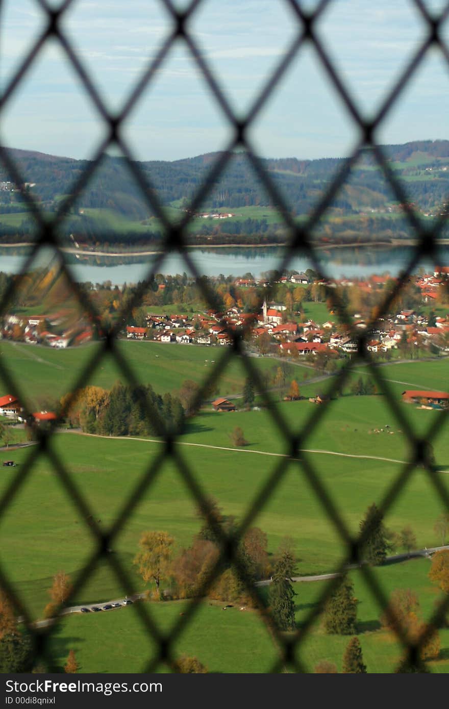 View out of neuschwanstein castle window to the village and lake in the distance