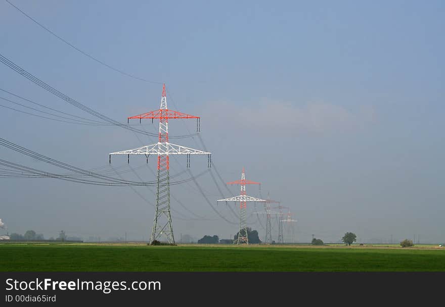 Red and white electricity pylons. Red and white electricity pylons