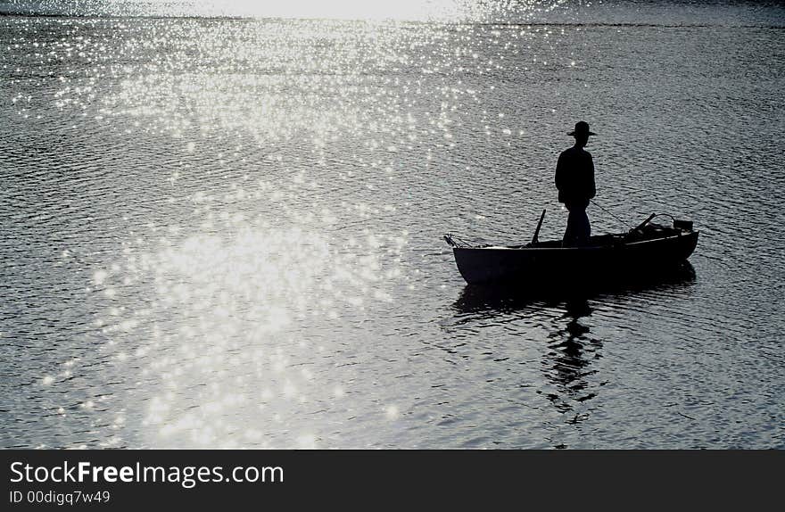 Silhouette of fisherman in boat