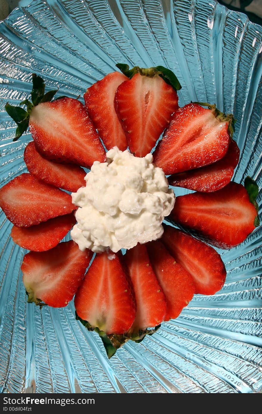 Strawberries and cottage cheese on a glass plate