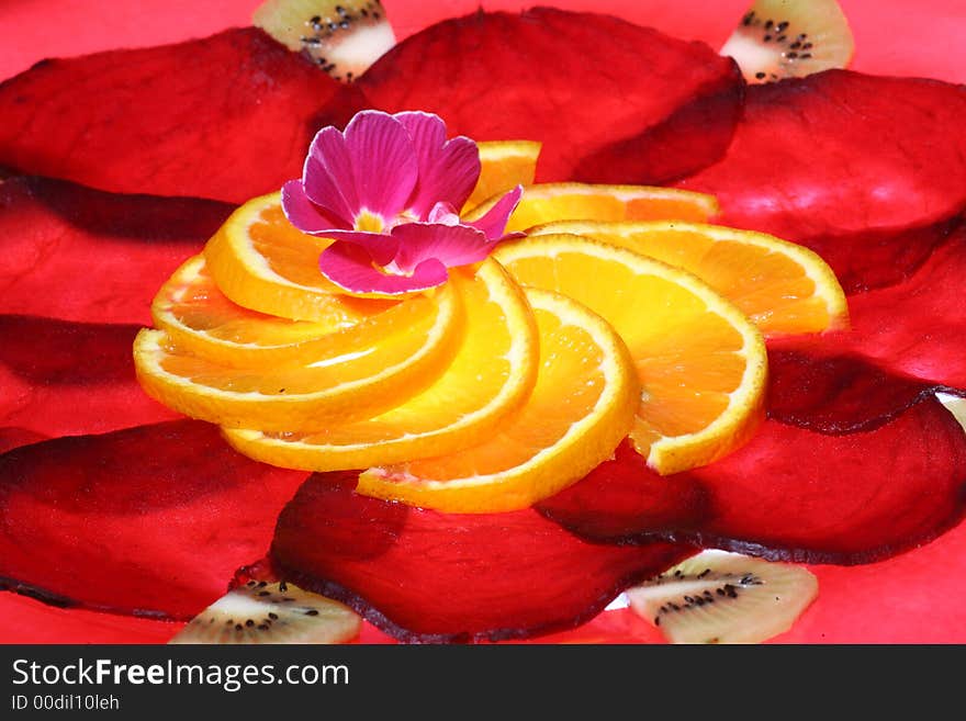 Arrangement of slices of beetroot and orange, a flower in the center. Arrangement of slices of beetroot and orange, a flower in the center.