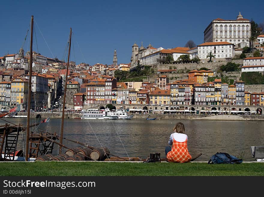 Blond girl near a river watching the sights