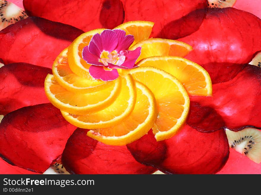 Arrangement of slices beetroot and orange, with flower in the center taken at an angle o app. 70 deg. Arrangement of slices beetroot and orange, with flower in the center taken at an angle o app. 70 deg.