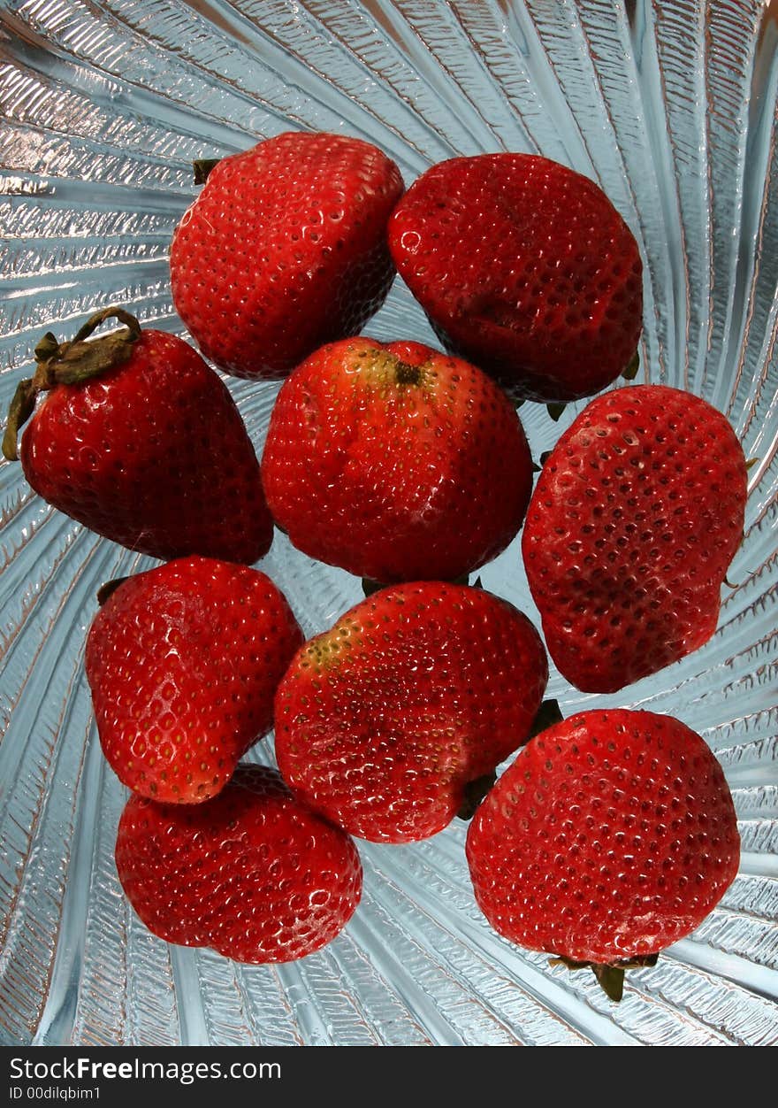 Nine strawberries on a wavy glass plate. Nine strawberries on a wavy glass plate