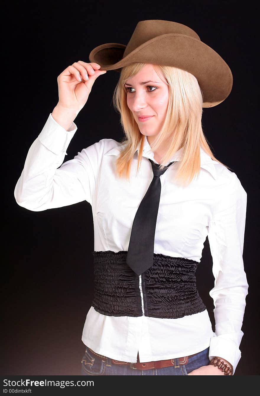 Beautiful sexy blonde cowgirl in studio with cowboy hat