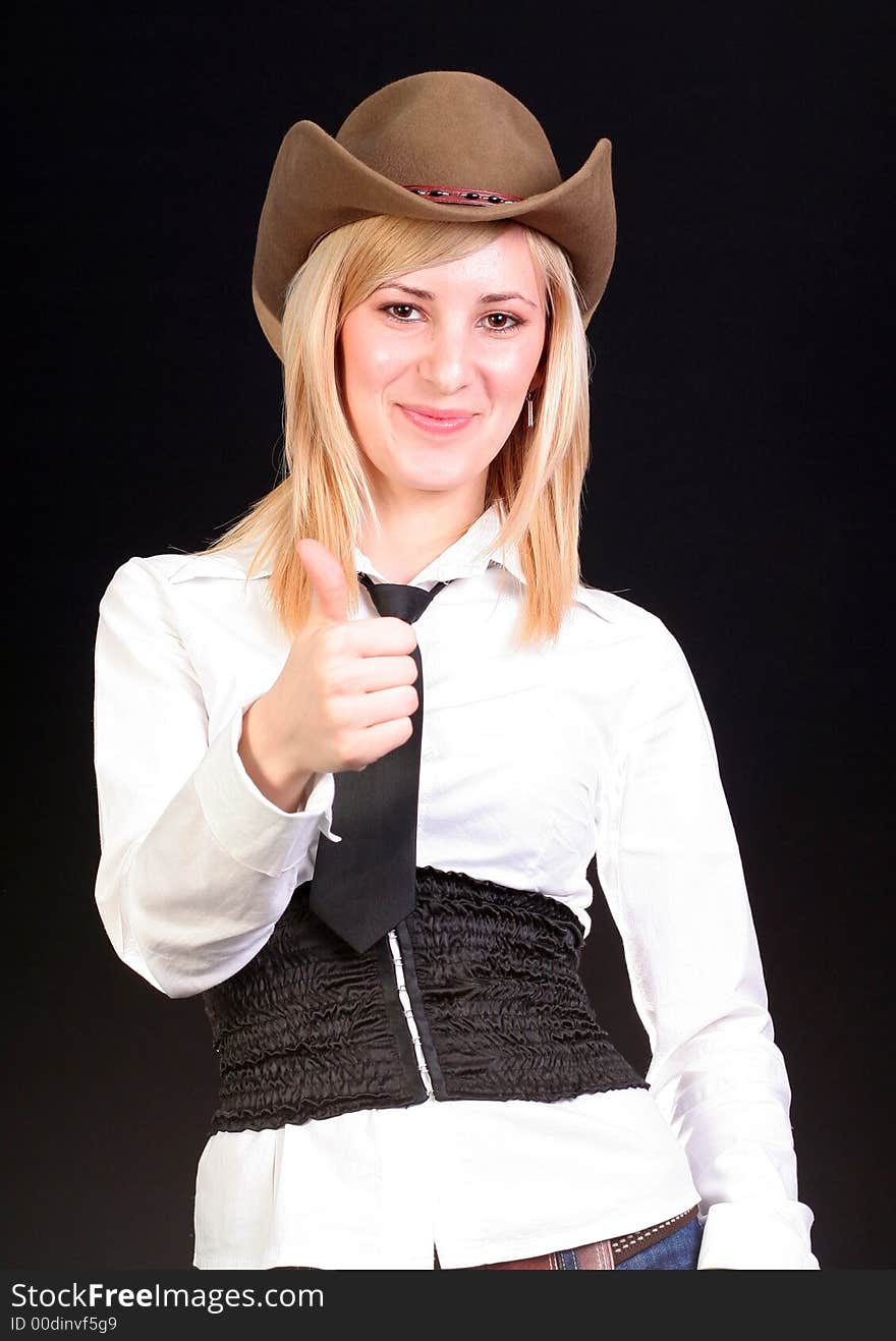 Beautiful sexy blonde cowgirl in studio with cowboy hat