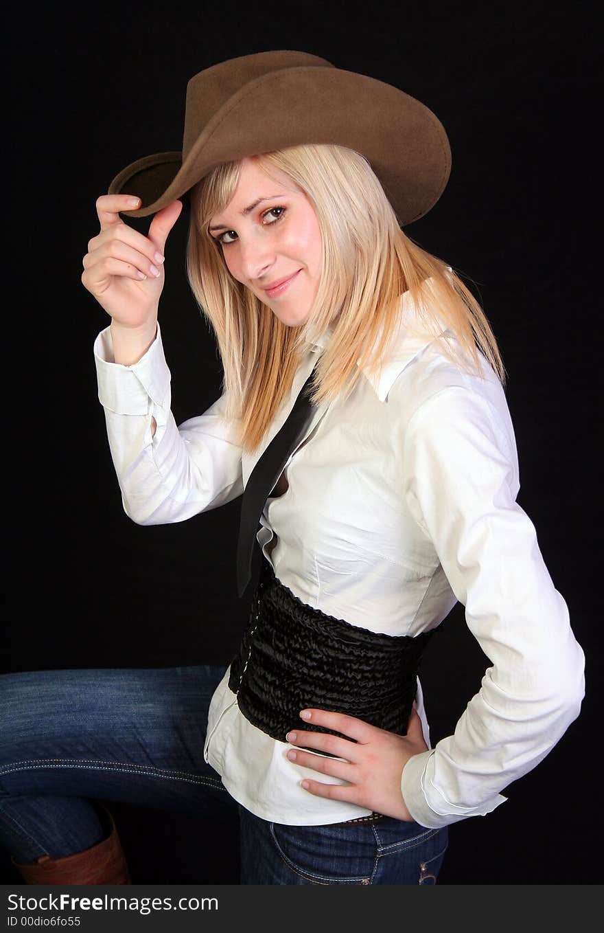 Beautiful blonde cowgirl in studio with cowboy hat