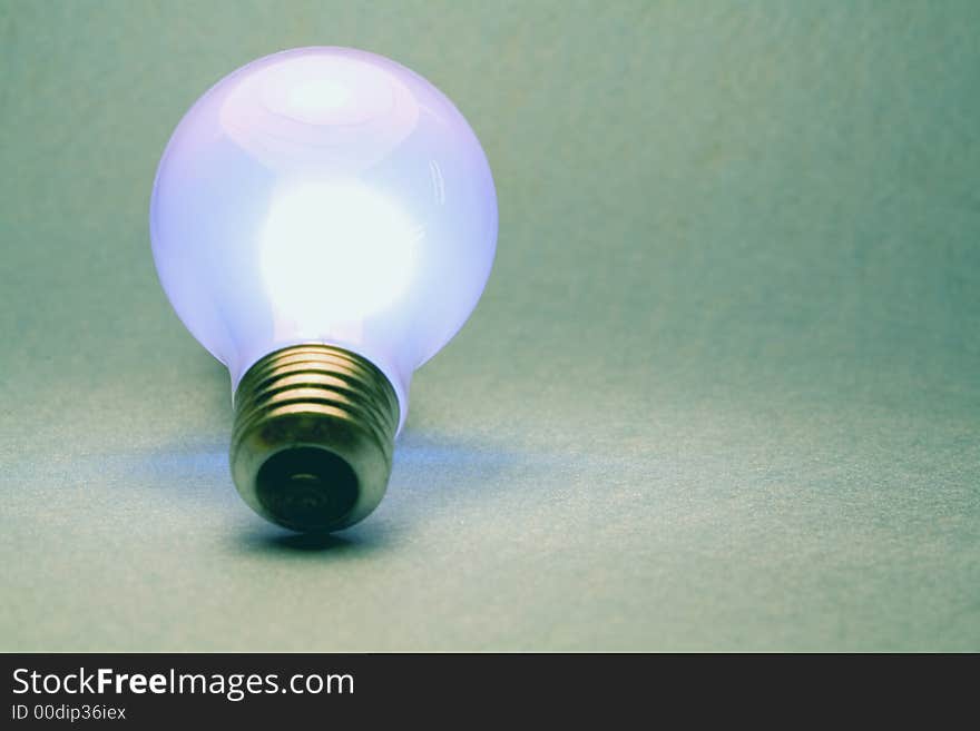 A shot of a glowing light bulb. A shot of a glowing light bulb