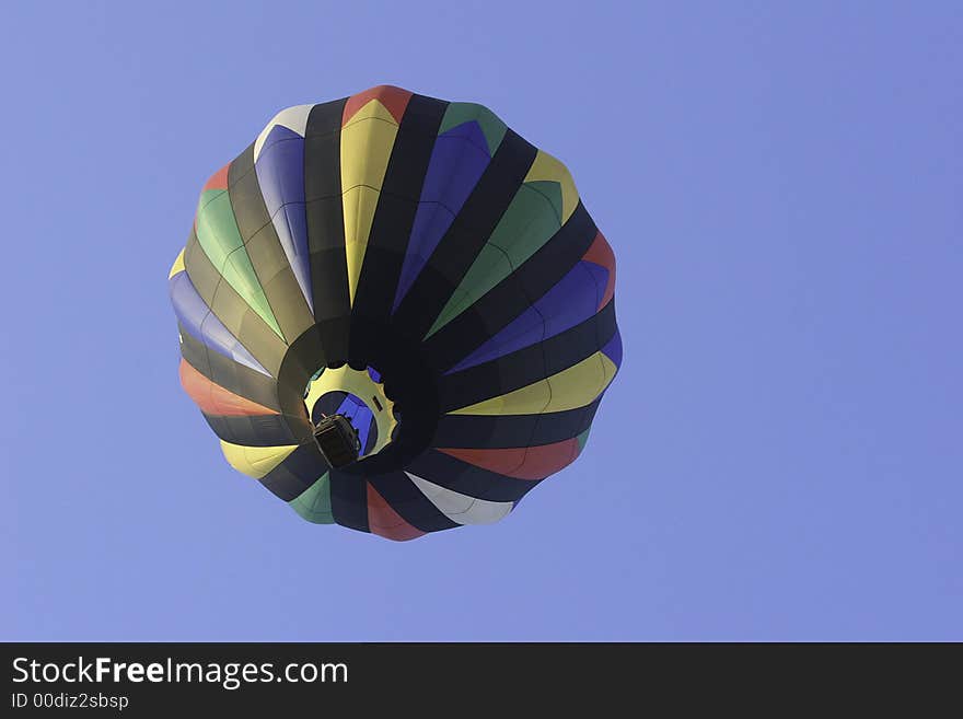 A colorful hot air balloon in flight taken from the ground