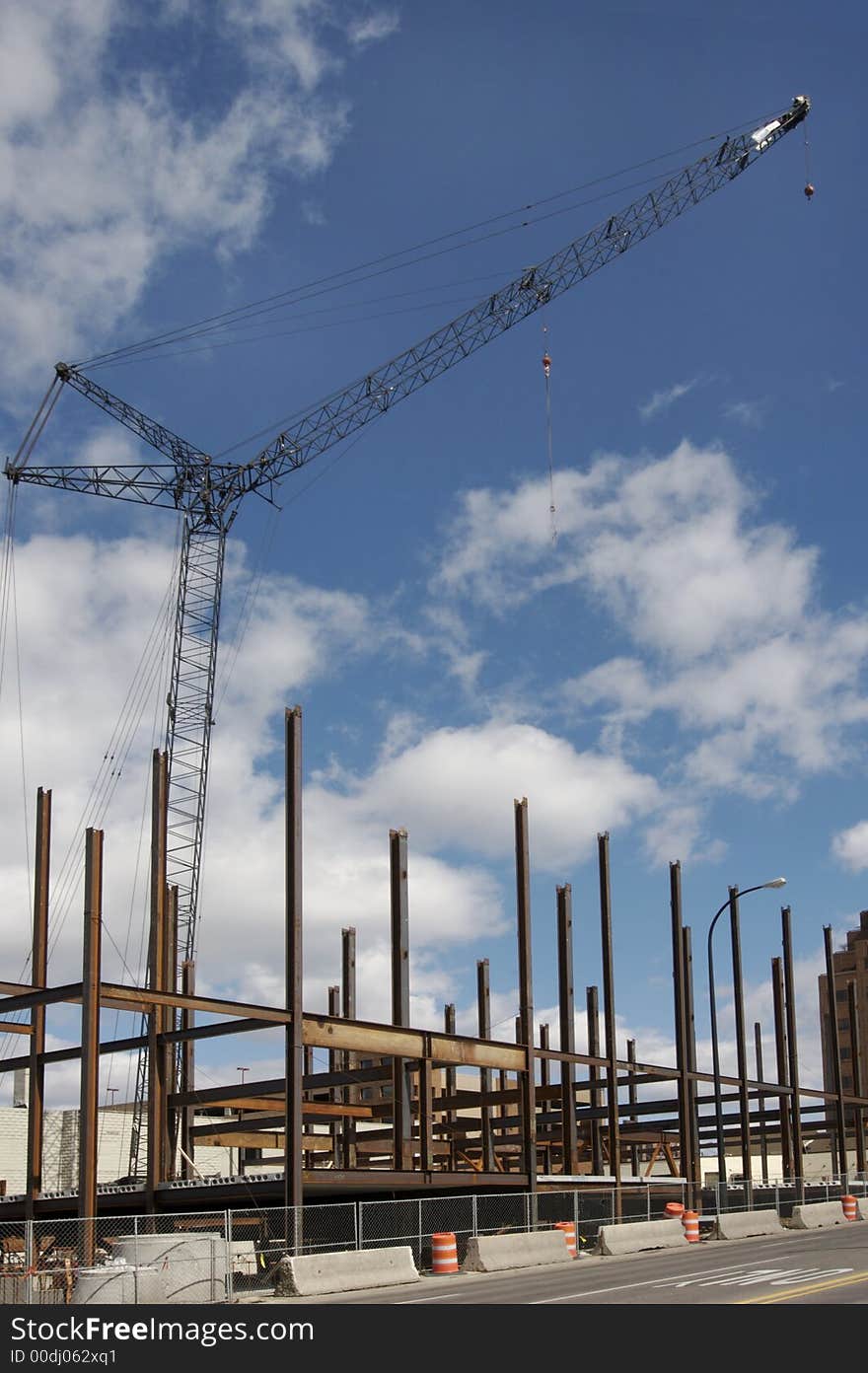 Construction crane and building girders against blue sky. Construction crane and building girders against blue sky