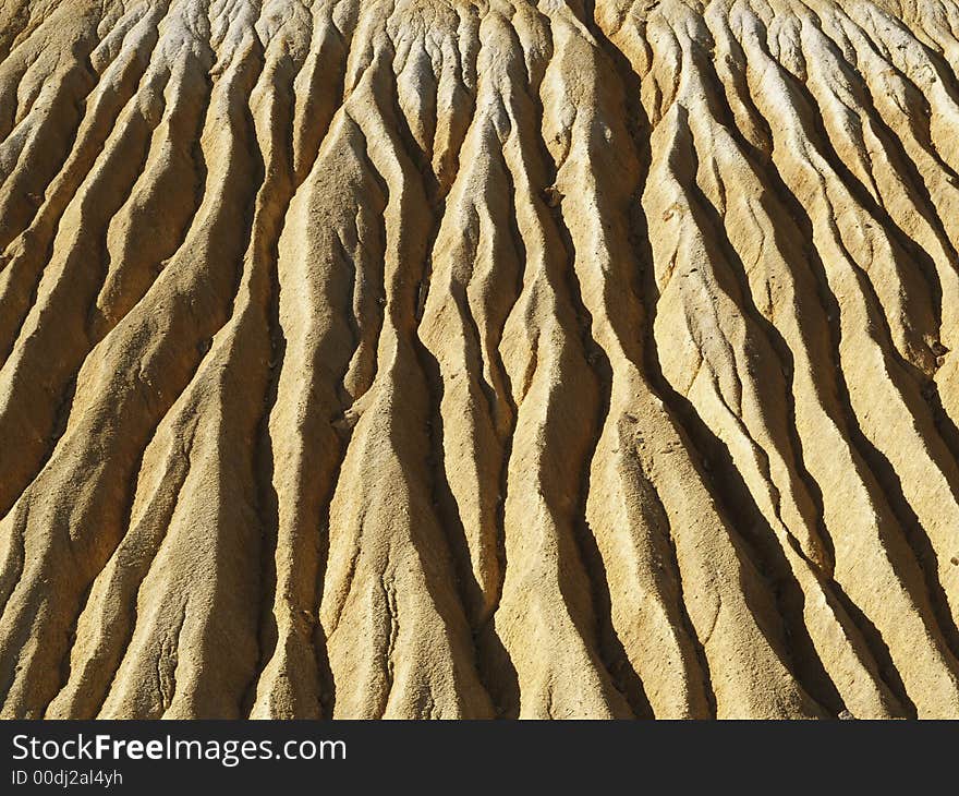 Mine tailings, hillside showing errosion creating gullies.