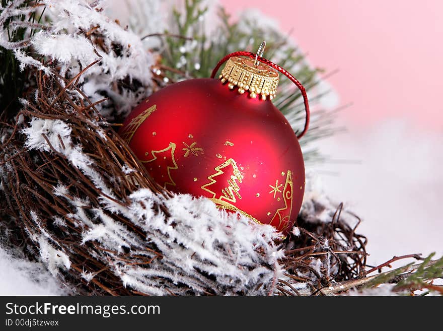 Red ornament in nest and snow. Red ornament in nest and snow