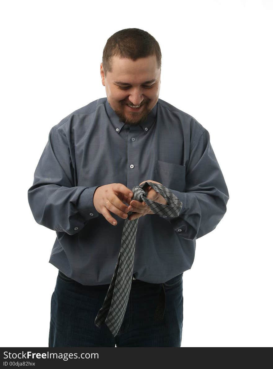 The man tries to fasten a tie. The man tries to fasten a tie