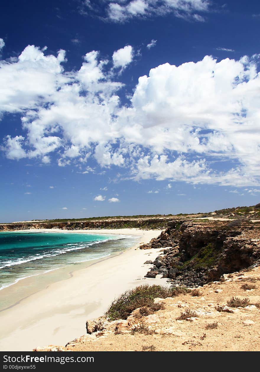 Seascape, with dramatic blue sky and white clouds, vertical. York Peninsula, South Australia.