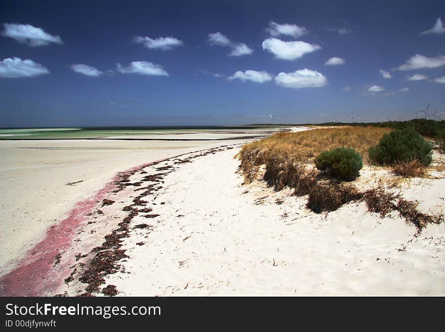 Beautiful beach with colorful sand, blue sky and white clouds. York Peninsula, South Australia. Beautiful beach with colorful sand, blue sky and white clouds. York Peninsula, South Australia.