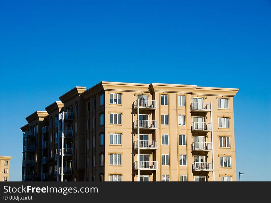 Modern beige and brown apartment condos on blue sky. Modern beige and brown apartment condos on blue sky