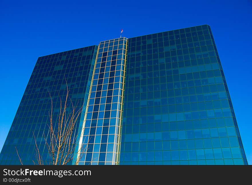 Office building of glass on a blue sky. Office building of glass on a blue sky