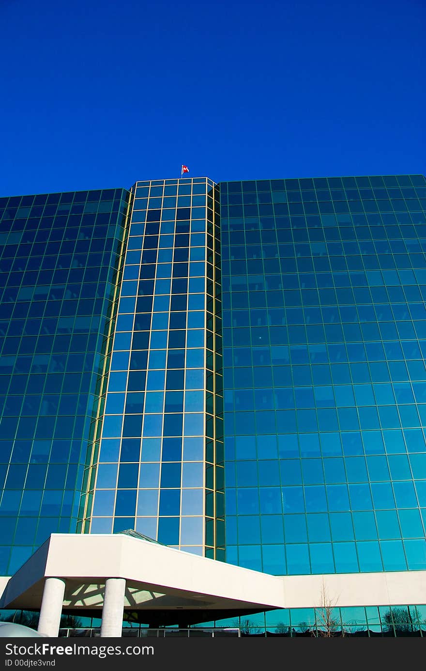 Office building of glass on a blue sky. Office building of glass on a blue sky