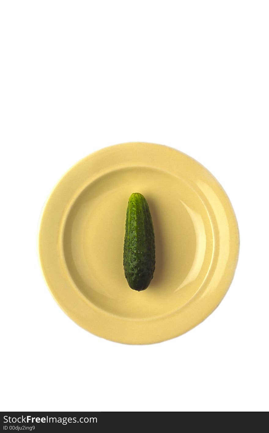 Green cucumber in  yellow plate on white background