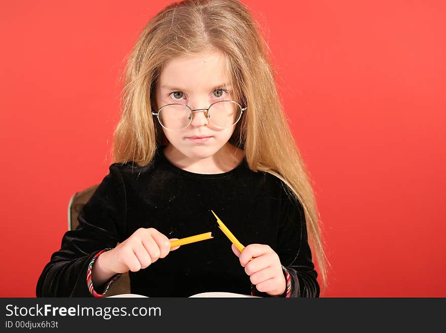 Mad little girl breaking pencil