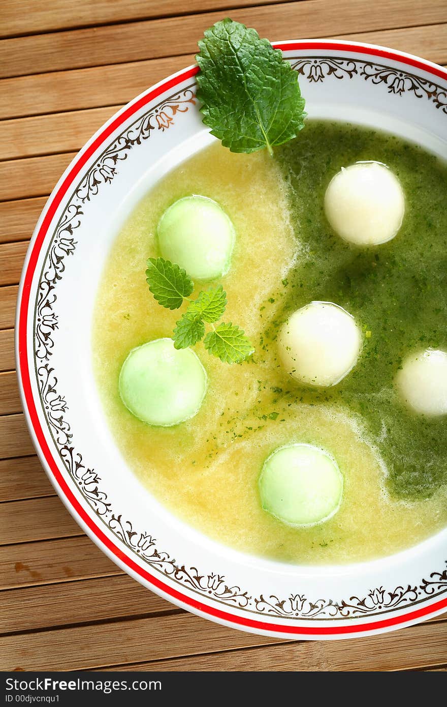 Tasty soup made from melon decorated mint on the plate