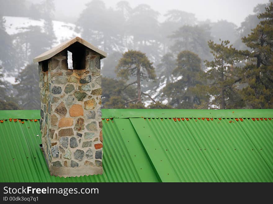 Roof with chimney in snow during winter at Troodos mountains in Cyprus