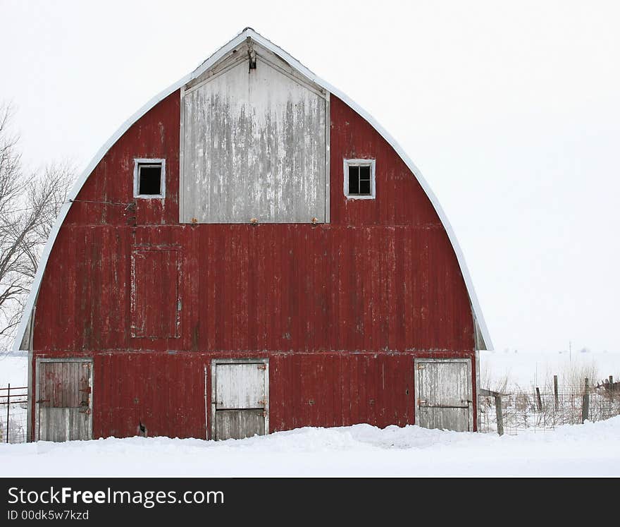 A photo of a red barn  on winter day in Iowa. A photo of a red barn  on winter day in Iowa.