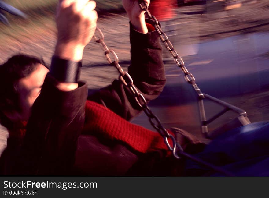 Motion blurred man on swing. Motion blurred man on swing