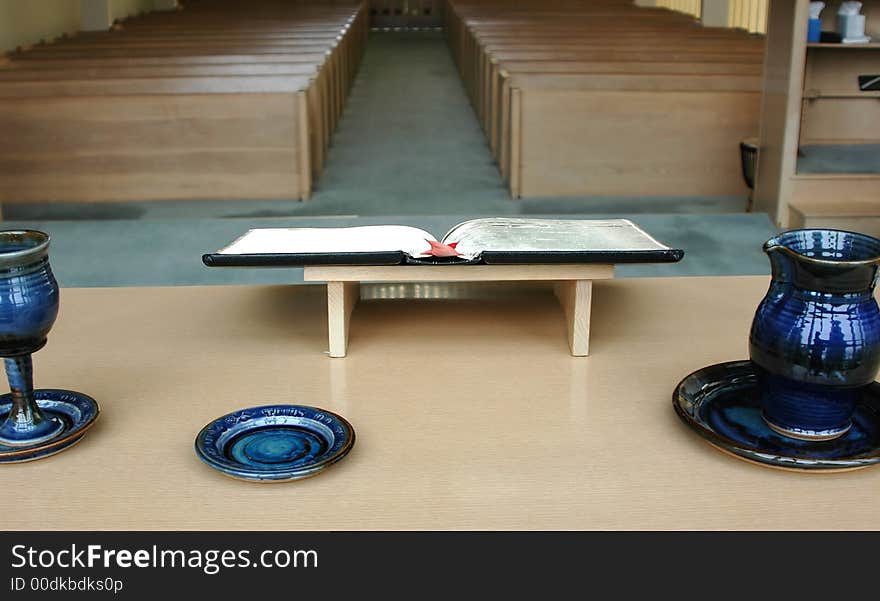 Inside view of a church with the bible open on a table. Inside view of a church with the bible open on a table.