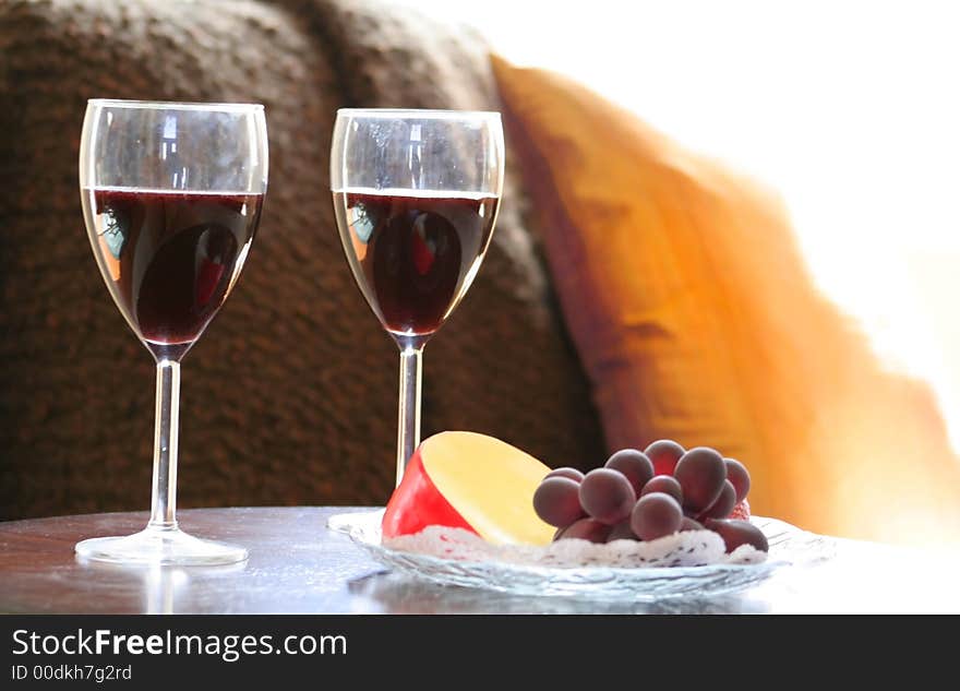 Close up shot of wine glasses and fruits