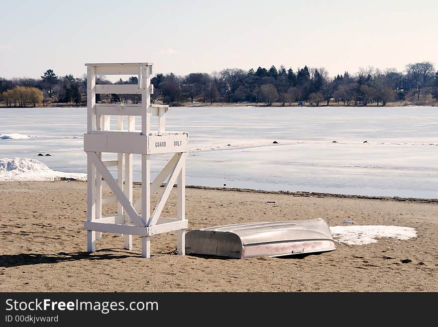 A picture of a life gaurd chair on the beach at the edge of winter. A picture of a life gaurd chair on the beach at the edge of winter.