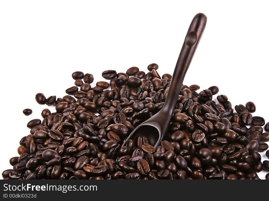 Some coffee bean with a wooden scoop. Some coffee bean with a wooden scoop.