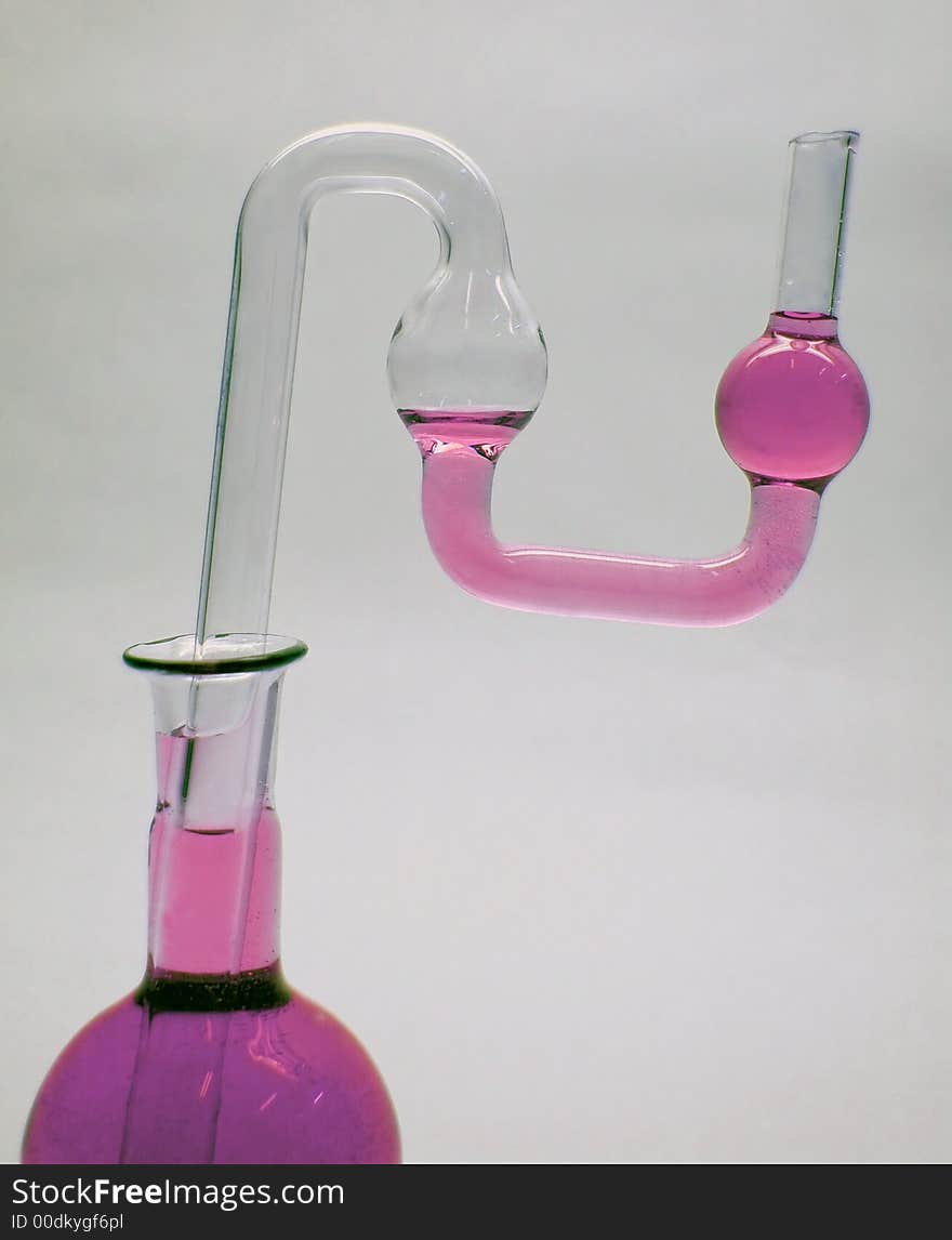 Chemical glass. Tube and flask with pink liquid. Chemical glass. Tube and flask with pink liquid