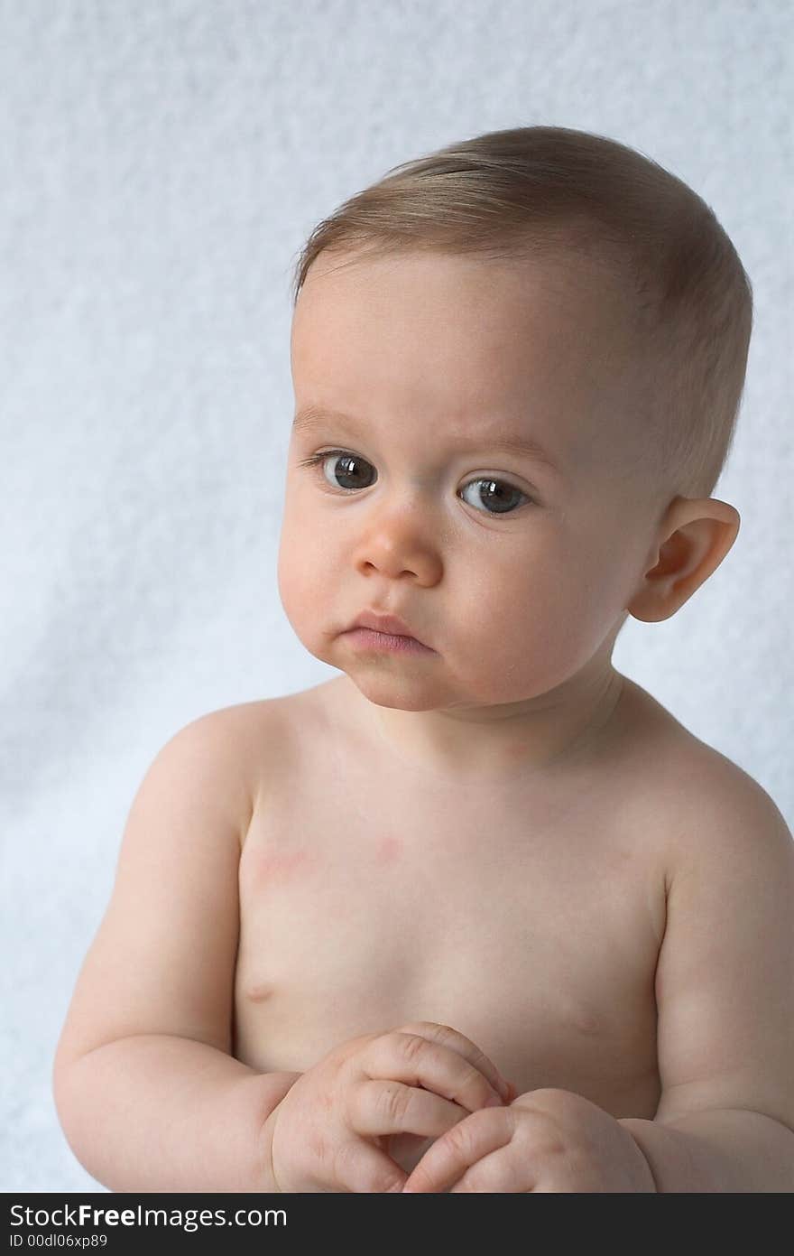 Image of beautiful 11 month old baby sitting in front of a white background. Image of beautiful 11 month old baby sitting in front of a white background