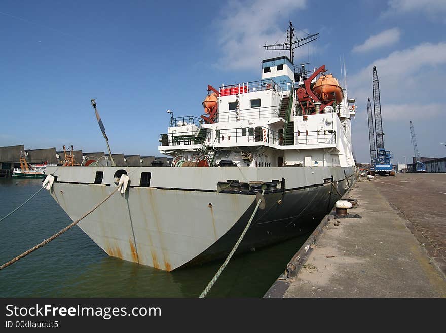 Ship in the harbour with loading cranes. Ship in the harbour with loading cranes