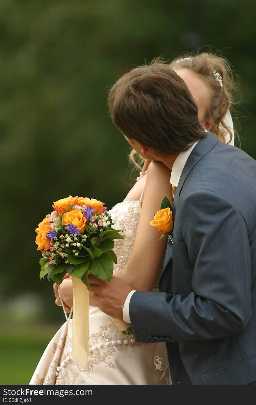 The groom gently embraces the bride. The groom gently embraces the bride